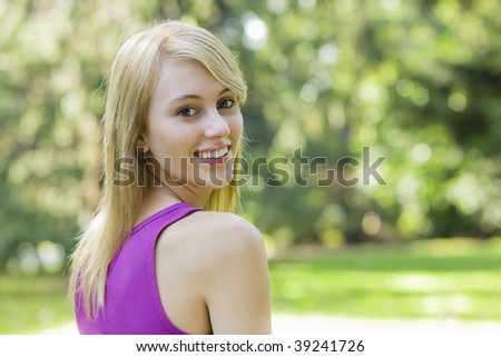 Pretty Teen Girl in a Park Looking Back Over Her Shoulder