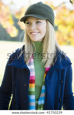 stock photo Portrait of a Pretty Blond Teen Girl Standing in a Park