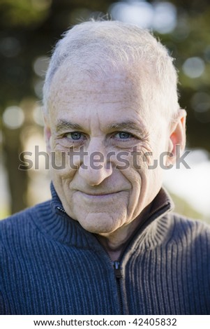 Portrait of a Smiling Old Man Looking To Camera