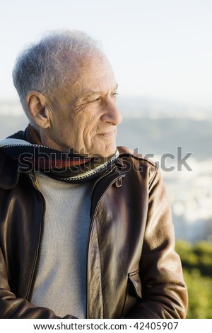 Profile of an Old Man Outdoors Wearing a  Scarf and Leather Jacket