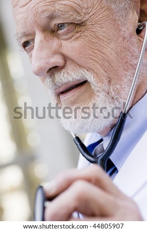 Profile of an Old Male Doctor Listing to a Stethoscope