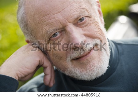 Portrait of an Old Gentleman Sitting on a Bench in a Park