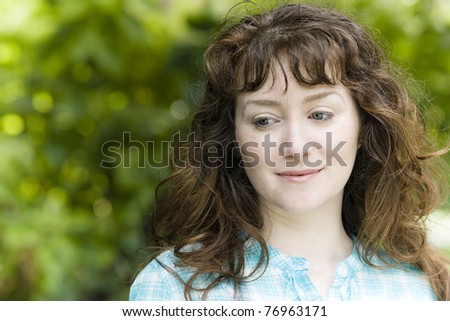 Portrait of a Pretty Young Woman Outside Looking Down to the Ground