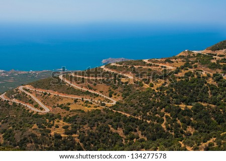 Mountain serpentine with many dangerous turns. Road near to Mediterranean sea at island of Crete, Greece