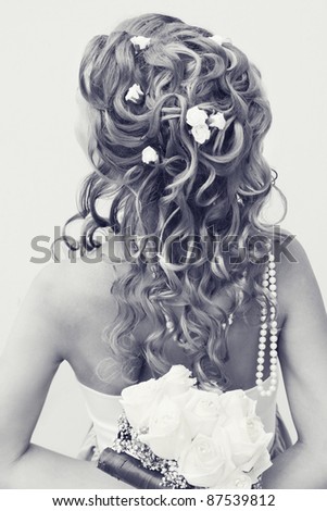 Beautiful stylish hairstyle with woven flowers