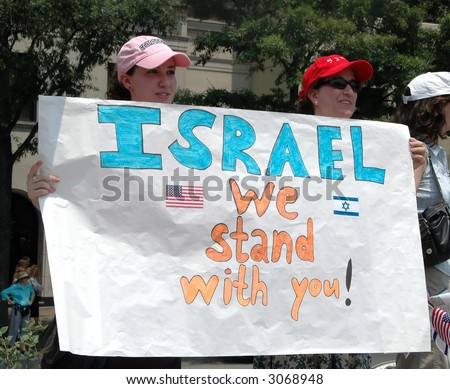 Two young girls holding pro-Israel sign at rally in Washington, DC