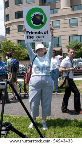 WASHINGTON, DC - June 4: Older female demonstrator holds up sign in protest against BP oil spill, June 4, 2010 in Washington, DC