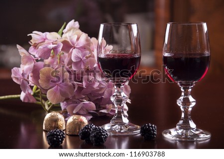 two glass of wine with chocolate and hydrangea flower