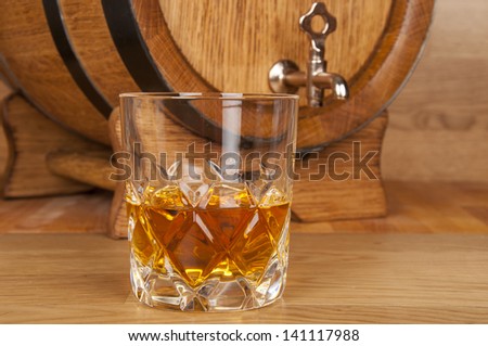 glass of whiskey and barrel