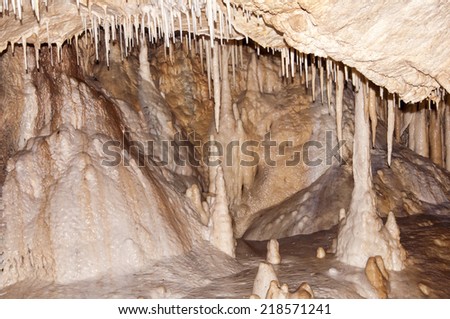Inside a large underground limestone cave - stalagmite ad stalactite in Cave of Bear in Poland