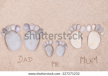 pairs feet (family)  made of a stone on the sea sand