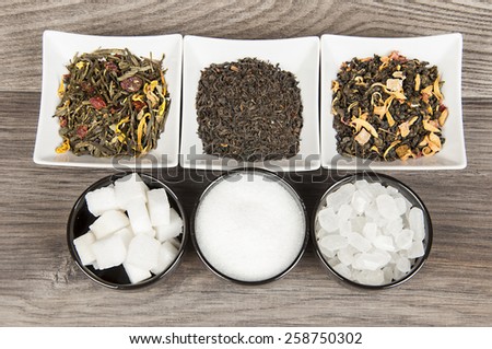 Various tea and various kind of sugar on wooden table