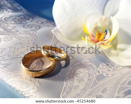 stock photo I love you gold wedding rings on silver and blue satin 