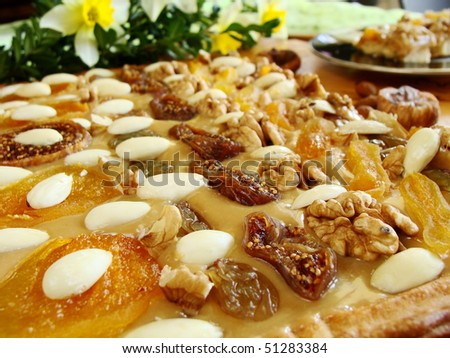 close up of cake with almonds, figs, apricots, nuts and with jonquils