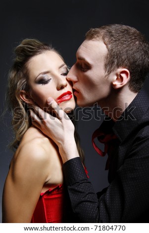 man kissing woman with smeared lipstick