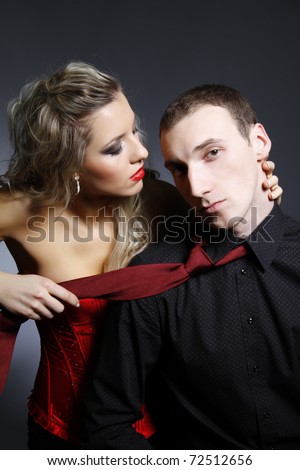 woman holding a man for a tie
