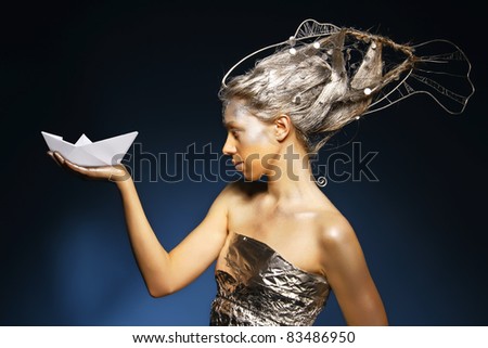 beautiful mermaid with a paper ship