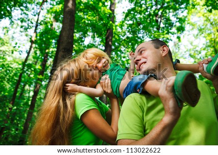 Portrait of a funny family having good time outdoors