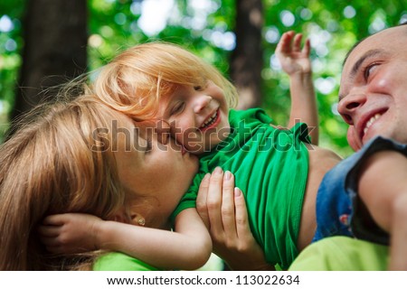 Portrait of a funny family having good time outdoors