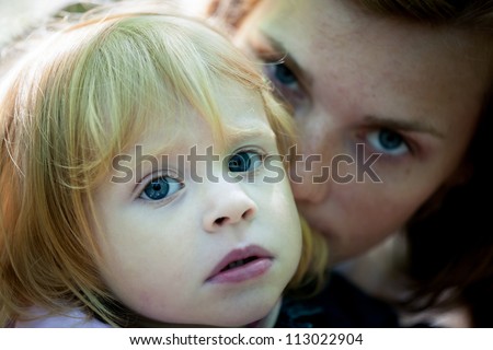 Sad portrait of mother and daughter - outdoor