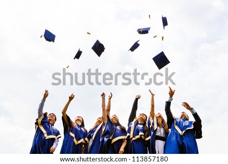Image of happy young graduates throwing hats in the air