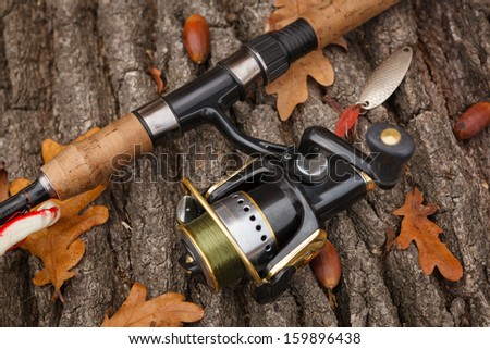 Fishing tackle on wooden weathered surface.