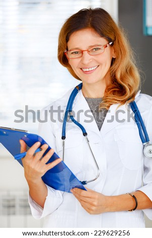 Portrait of family doctor looking at camera and smiling.