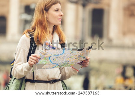 Young beautiful woman traveler with map.