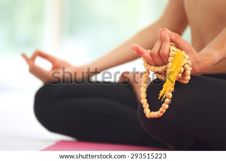 Young beautiful woman meditating in lotus pose.