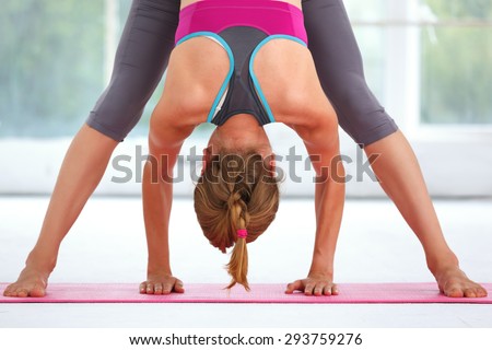Young beautiful woman doing yoga indoors.
