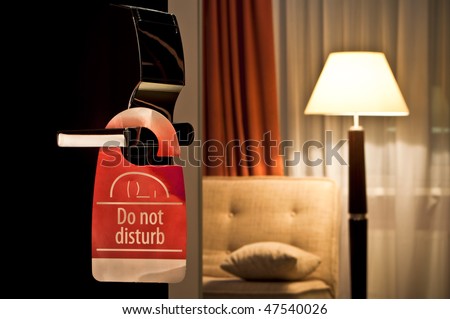 do not disturb sign hanging on open door in a hotel