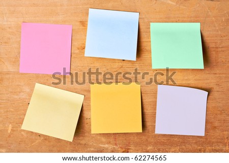 sticky notes sticked to wooden board