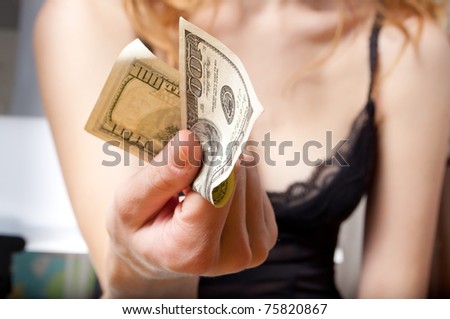 Young woman holding a dollar banknote in her hand