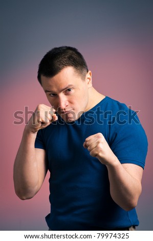 This is a photograph of a young man standing in a boxing position