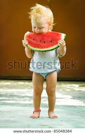 Cute infant baby with a delicious melon