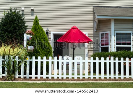 Small patio with red umbrella