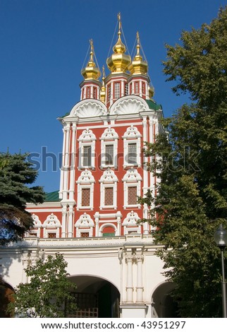 Monastery gate and five domes church in Russia