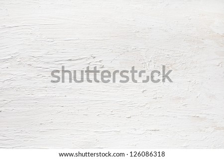 Detail of white painted and plastered wall.  Rough texture on wooden board.