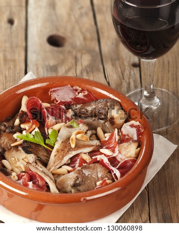 Oyster mushrooms, serrano ham and pine nuts tapas.  Setas con jamon y pinones with rioja red wine