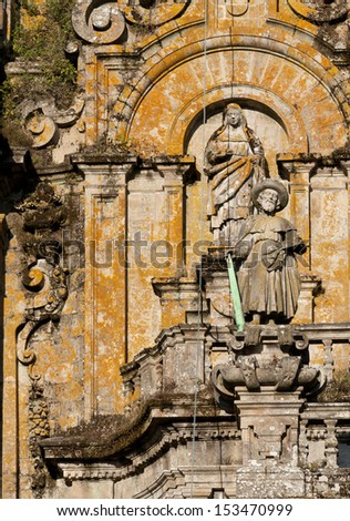 Figure of St. James,pilgrim, with hat, staff and sword in the facade of the Cathedral of Santiago de Compostela, Galicia, Spain.  He used the sword to help kill  Moors in the reconquest of Spain.