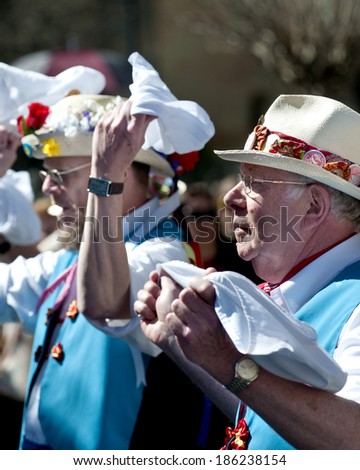 SEGOVIA  SPAIN - MARCH 16 2014 - East Suffolk Morris Men dancing in the Roman city of Segovia, Spain with blue and white uniform, bells and straw hats with flowers.  Traditional English folk dancing.