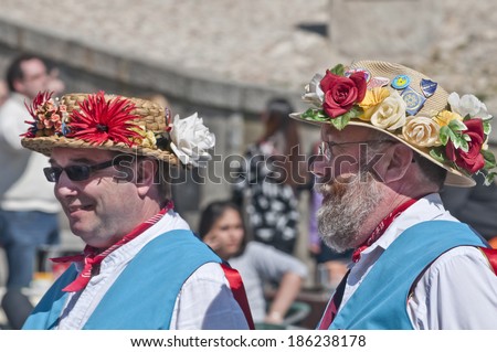 SEGOVIA  SPAIN - MARCH 16 2014 - East Suffolk Morris Men  in the Roman city of Segovia, Spain with blue and white uniform, and straw hats decorated with flowers.  Traditional English folk dancers