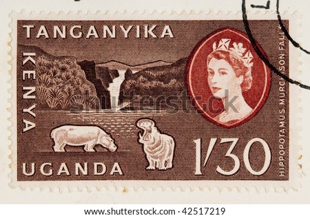 CIRCA 1960: A stamp printed in East Africa from a first day cover of an animal and plant series showing an image of a pair of hippos and a waterfall, circa 1960.