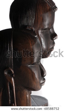 Two masai warrior carved mahogany heads from Kenya, isolated on white.