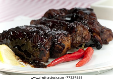 Very sticky roasted and grilled pork spare rib with rosemary, garlic and chili glazed with a brown  sugar and balsamic vinegar sauce.