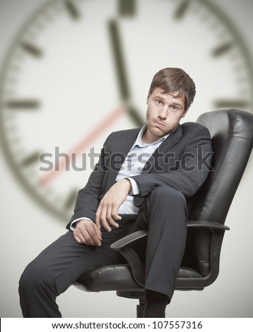 stock-photo-frustrated-young-business-man-waiting-for-the-end-of-the-workday-107557316.jpg