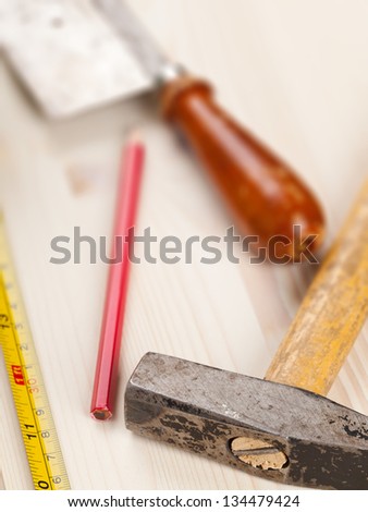 Wooden plank with measurement tape and tools with selective focus