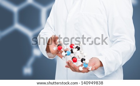 Scientist analyzing chemical molecule model with blue background