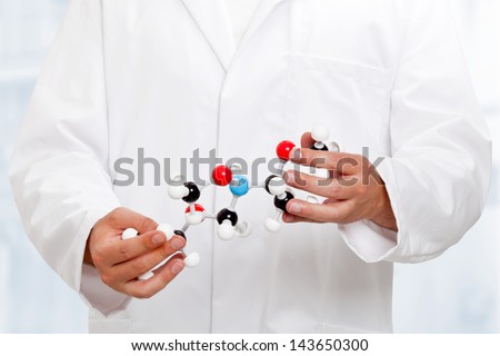 Scientist analyzing chemical molecule model with blue background