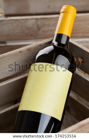 White wine bottle with empty label in wooden crate